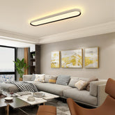 Modern living room with gray sofa, coffee table, and ceiling light fixture.